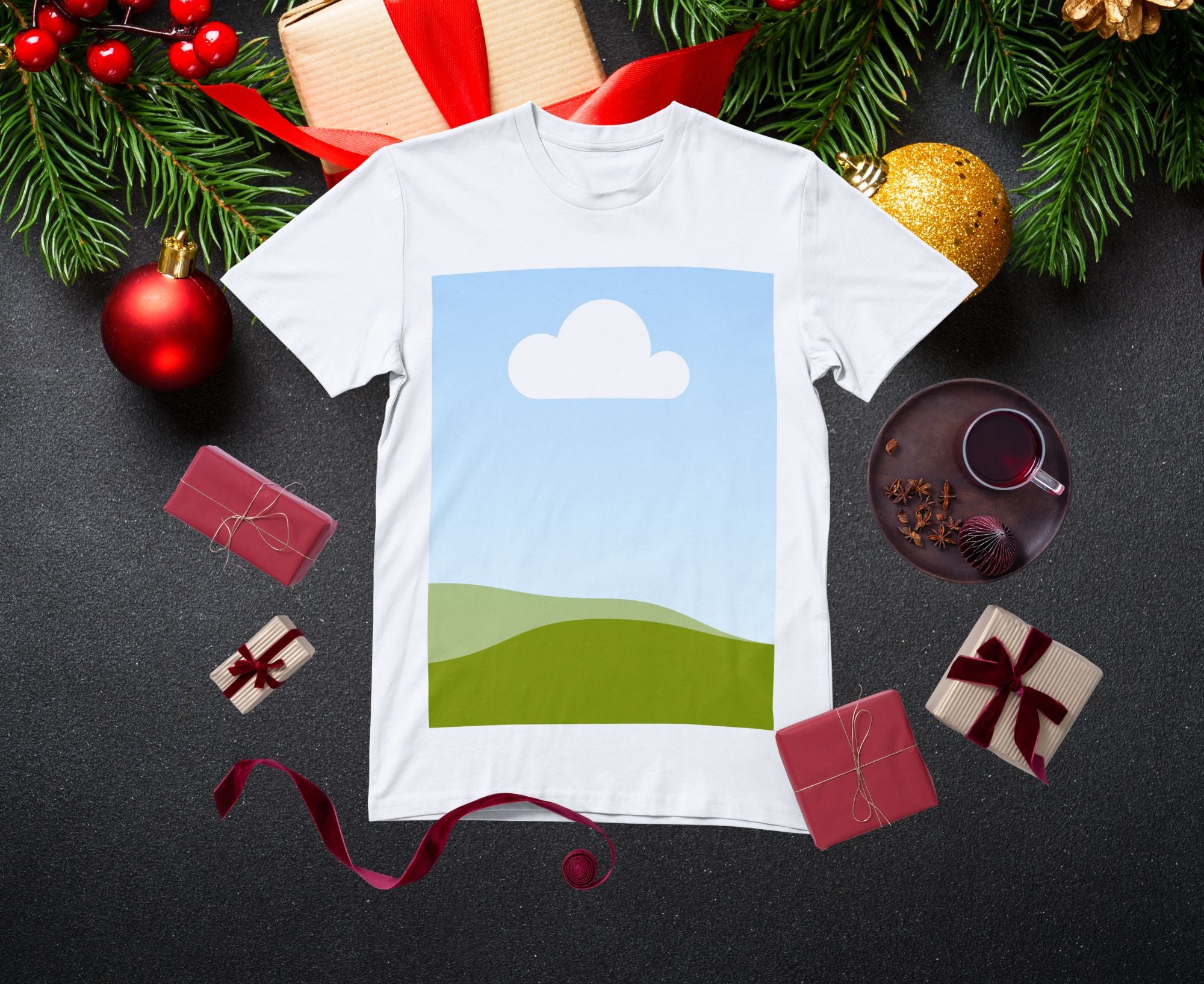 White t-shirt with a scenic design on a dark surface with Christmas decorations